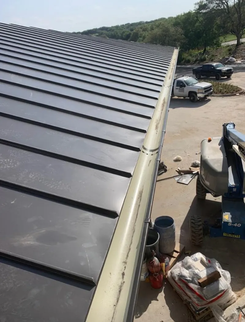 Standing seam panel and gutter detail on a metal roofing jobsite in Brooklyn Center